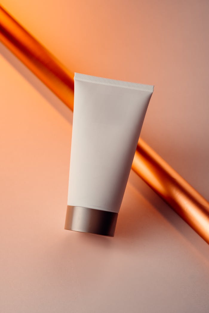 Close-up of a skincare cream tube with a modern gradient background, perfect for beauty product marketing.